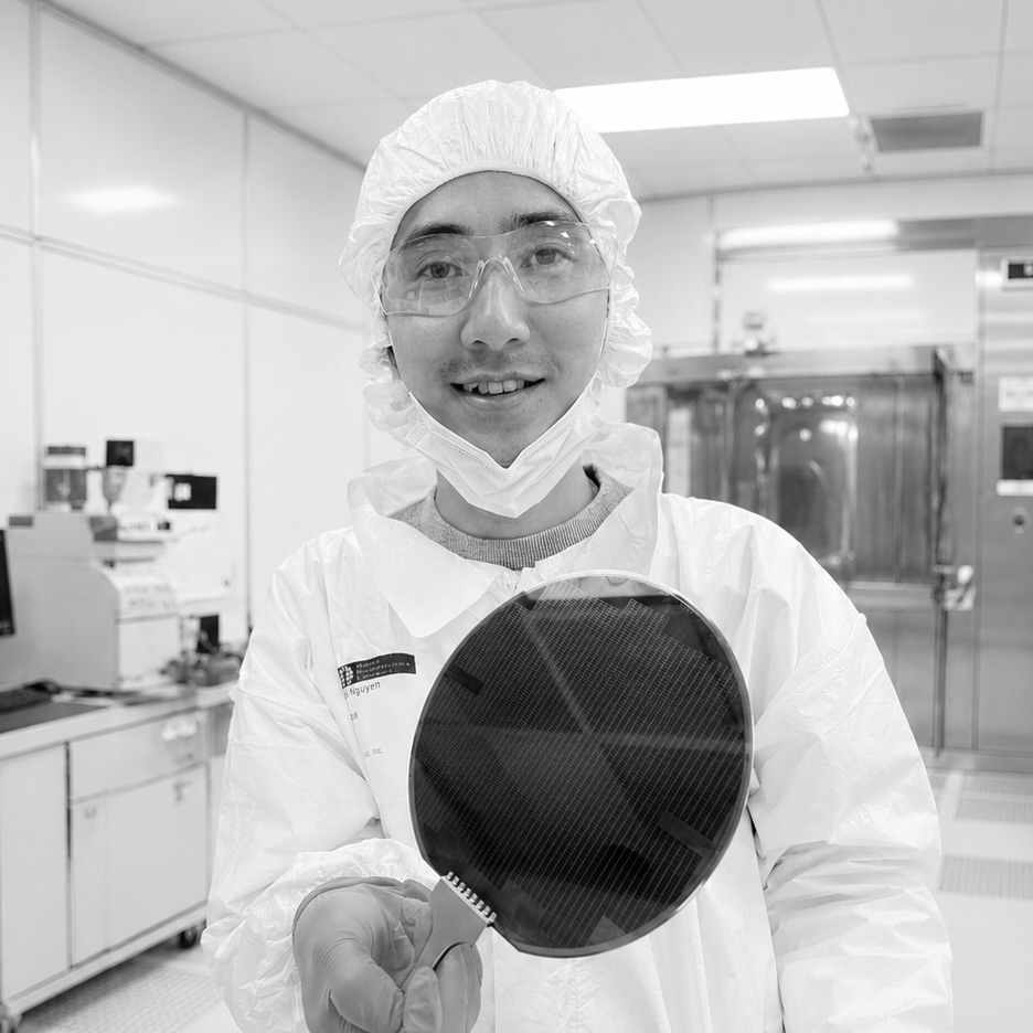 Serinus Labs engineer holding a semiconductor wafer in a cleanroom